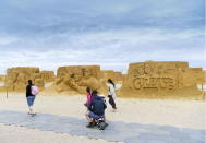 Visitors walks along the cobbled path next to these golden tributes of Grease and Dirty Dancing.