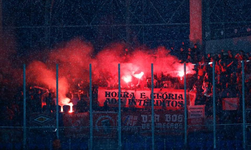 Benfica’s supporters light flares ahead of the match against Real Sociedad.