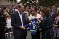 B.C. Premier Christy Clark gives Vancouver Canucks jerseys with the names of their kids George and Charlotte to the Duke and Duchess of Cambridge following their visit to the Cridge Centre for the Family during a tour of the centre in Victoria, B.C., Saturday, October 1, 2016. THE CANADIAN PRESS/Chad Hipolito