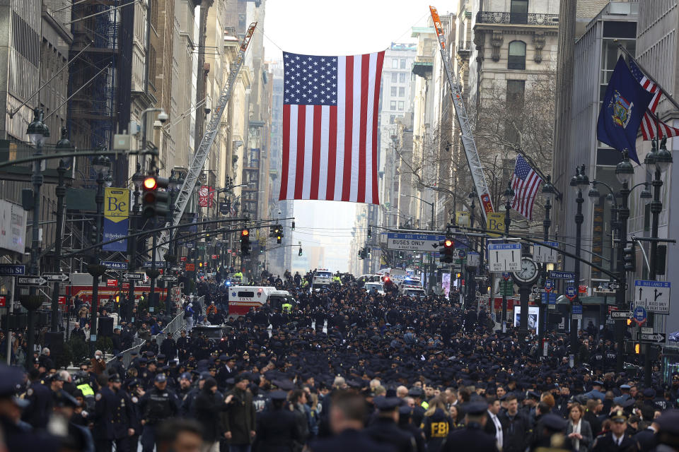 New York Police officers begin to arrive along Fifth Avenue outside St. Patrick's Cathedral for Officer Wilbert Mora's funeral, Wednesday, Feb. 2, 2022, in New York. For the second time in under a week, police converged on New York City's St. Patrick's Cathedral to pay tribute to a young officer gunned down while answering a call for help in Harlem. Mora was shot along with Officer Jason Rivera on Jan. 22 while responding to a call about a domestic argument in an apartment. (AP Photo/Yuki Iwamura)