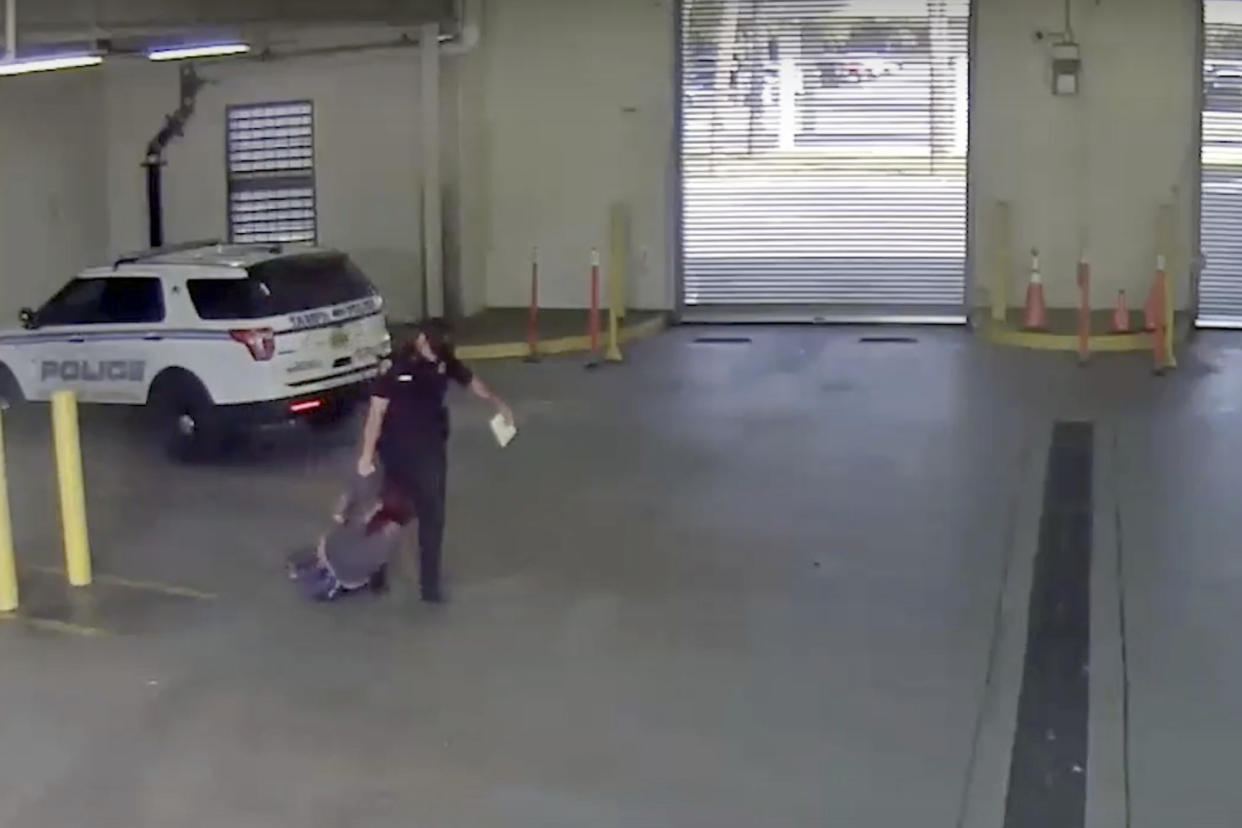 In this image taken from video released by the Tampa Police Department, police officer Gregory Damon drags a woman across the floor at Orient Road Jail in Tampa, Fla., on Nov. 17, 2022. Damon, who was videotaped dragging a handcuffed woman on the floor has been fired, authorities said. An internal investigation determined that former officer violated department policies during the Nov. 17 incident, the Tampa Police Department announced Tuesday, Dec. 27, 2022 in a news release. (Tampa Police Department via AP)