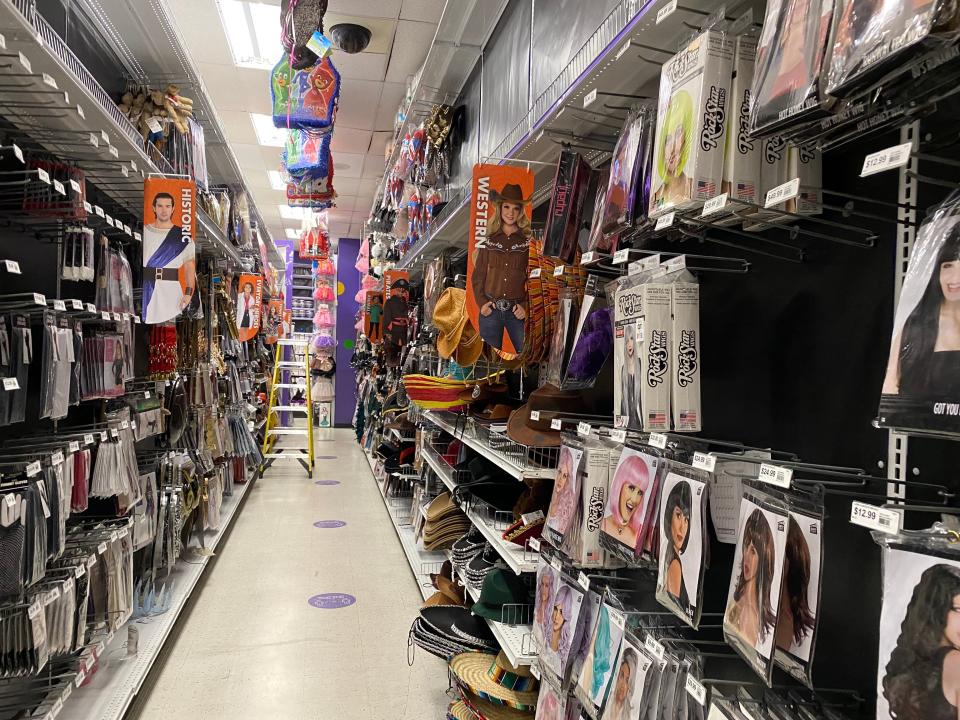 Themed aisle filled with western costumes at party city