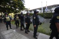 Police stand outside the residence of Uruguay's ambassador to Peru, in Lima, Peru, Sunday, Nov. 18, 2018. Former Peruvian President Alan Garcia has sought asylum in Uruguay's diplomatic mission hours after a judge retained his passport as part of a corruption probe, Peru's foreign ministry announced Sunday. (AP Photo/Karel Navarro)