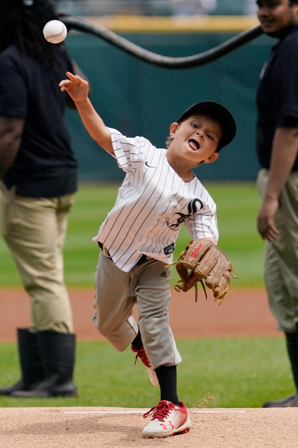Beau Dowling throws out a ceremonial first pitch before a baseball game between the Baltimore Orioles and the Chicago White Sox in Chicago, Saturday, June 25, 2022. (AP Photo/Nam Y. Huh)