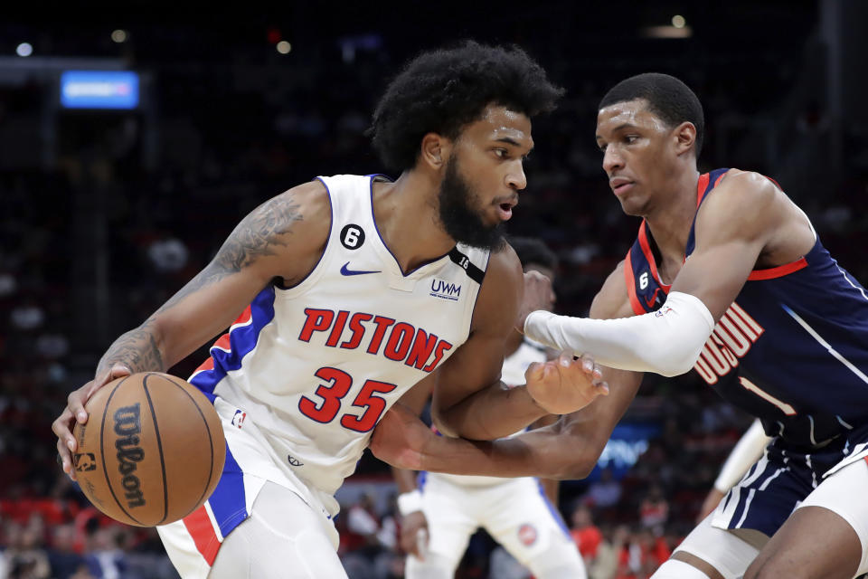 Detroit Pistons forward Marvin Bagley III (35) attempts to drive around Houston Rockets forward Jabari Smith Jr. (1) during the first half of an NBA basketball game Friday, March 31, 2023, in Houston. (AP Photo/Michael Wyke)