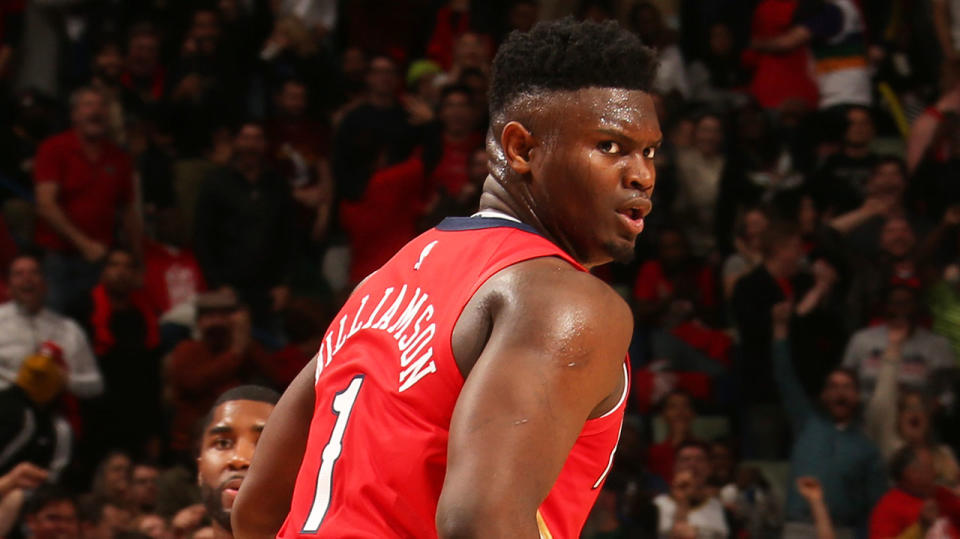 Zion Williamson reacts and runs down the court after lighting up the NBA on his debut.