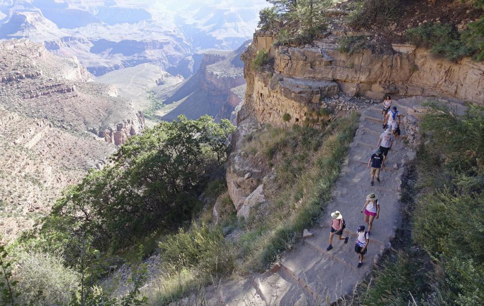 FILE - In this July 27, 2015, file photo, the busy Bright Angel Trail is crowded with hikers headed down into the Grand Canyon at Grand Canyon National Park, Ariz. The Interior Department is considering recommendations to modernize campgrounds within the National Park Service. (AP Photo/Ross D. Franklin, File)