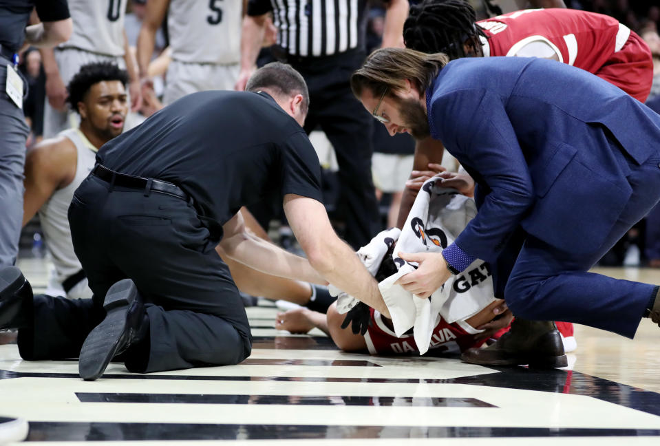 Medical professionals tend to Oscar da Silva of the Stanford Cardinal as he lays motionless on the court after fouling Evan Battey of the Colorado Buffaloes during the second half of their matchup on Saturday in Boulder.