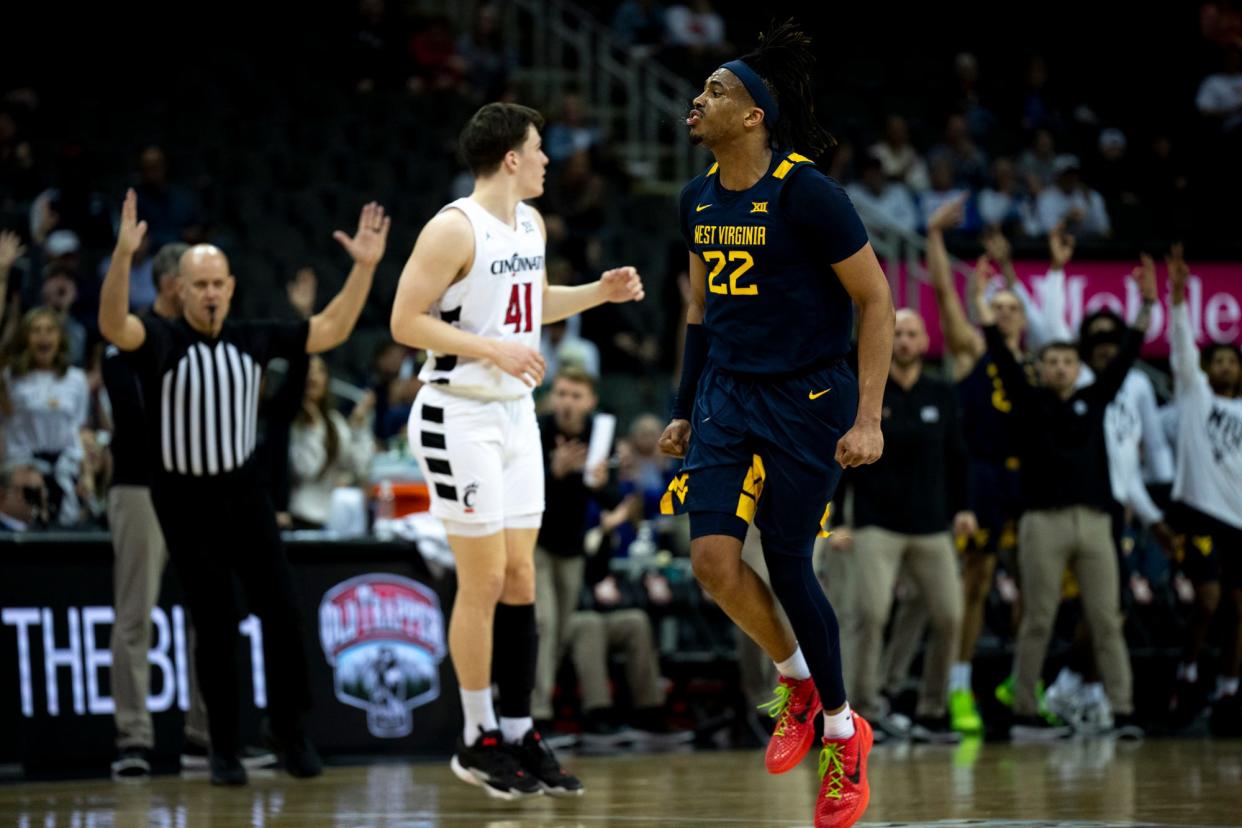 West Virginia forward Josiah Harris (22) celebrates in the second half of the Big 12 tournament against Cincinnati, Tuesday, March 12, 2024, in Kansas City, Mo.