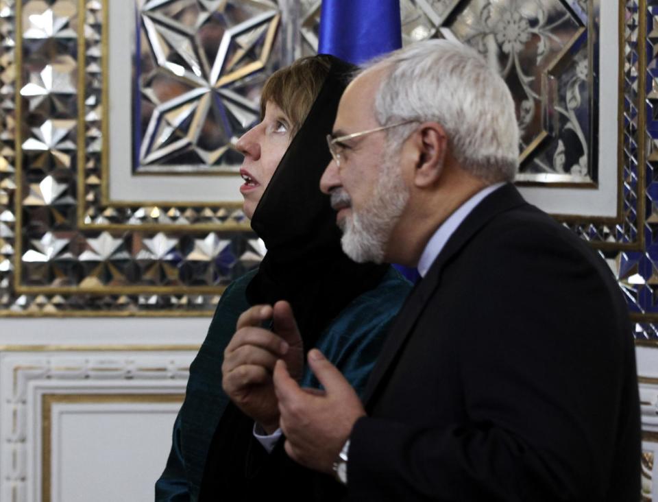 Iranian Foreign Minister Mohammad Javad Zarif, right, welcomes European Union's foreign policy chief Catherine Ashton for their meeting, in Tehran, Iran, Sunday, March 9, 2014. Ashton is saying there is no guarantee for a successful final nuclear deal with Iran. (AP Photo/Vahid Salemi)