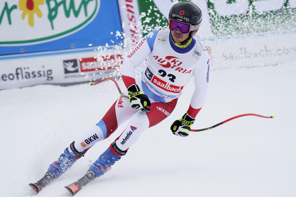 Switzerland's Gino Caviezel arrives at the finish area of an alpine ski, men's World Cup Super G, in Saalbach-Hinterglemm, Austria, Friday, Feb. 14, 2020. (AP Photo/Giovanni Auletta)
