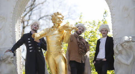 "Barock 'n' Rollers" Johann Sebastian Bass pose next to a statue of Johann Strauss in Vienna, Austria, April 24, 2015. REUTERS/Leonhard Foeger