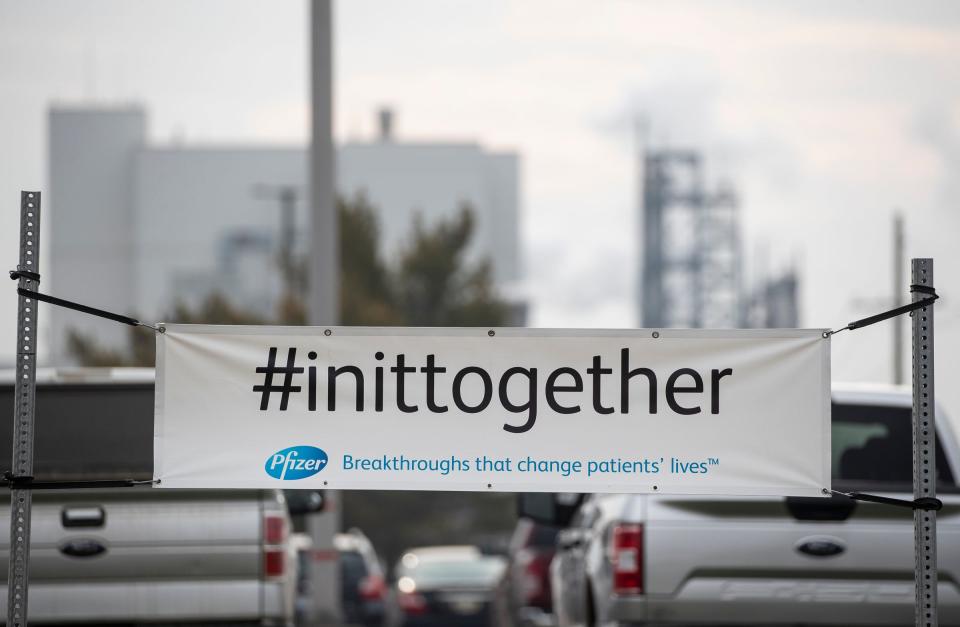 A #inittogether banner is seen at Pfizer Global Supply in Kalamazoo, Mich., Friday, Dec. 11, 2020.