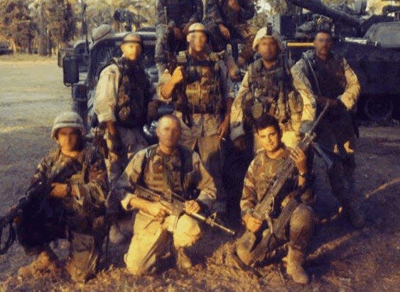 Glenn Girona, pictured front right, and his platoon in Baghdad, 2003.