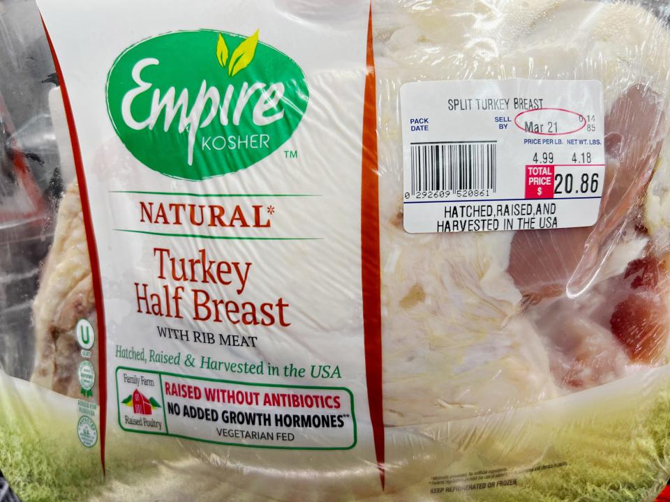 A package of a half of turkey breast showing the meat. The label reads "Empire kosher natural turkey half breast"