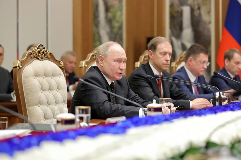 Vladimir Putin and officials from his administration speak at negotiations between North Korea and Russia.