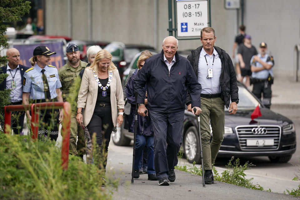 Norway's King Harald and Queen Sonja, rear, visit Mjoendalen, Norway, Friday Aug. 11, 2023, to greet volunteers and get an overview of the flood area in the Drammensvassdraget. Authorities were on standby to evacuate more people in southeastern Norway Friday, where huge amounts of water, littered with broken trees, debris and trash, were thundering down the usually serene rivers after days of torrential rain. (Stian Lysberg Solum/NTB via AP)