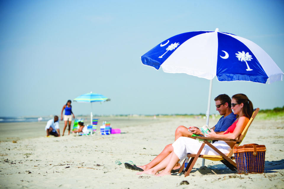 In this file photo provided the Charleston Area Convention & Visitors Bureau, people sit on a beach in Kiawah Island, S.C. Nearby Beachwalker Park on Kiawah Island is tenth on the 2013 list of Top 10 Beaches produced annually by coastal expert Stephen P. Leatherman, also known as "Dr. Beach," director of Florida International University's Laboratory for Coastal Research. (AP Photo/Charleston Area Convention & Visitors Bureau, File)