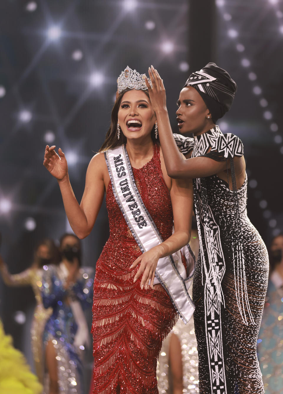 This image released by Miss Universe Organization shows Miss Universe Mexico 2020 Andrea Meza being crowned Miss Universe by Miss Universe 2019 Zozibini Tunzi at the 69th Miss Universe Competition at the Seminole Hard Rock Hotel & Casino in Hollywood, Fla. on Sunday, May 16, 2021. (Tracy Nguyen/Miss Universe via AP)