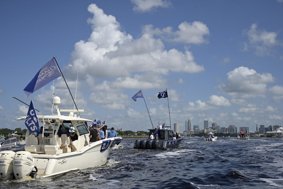 Boats carrying Tampa Bay Lightning players are viewed with the downtown skyline in the distance during the NHL hockey Stanley Cup champions' Boat Parade, Monday, July 12, 2021, in Tampa, Fla. (AP Photo/Phelan M. Ebenhack)