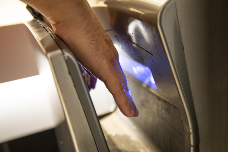 Man Drying Hands In Special Machine