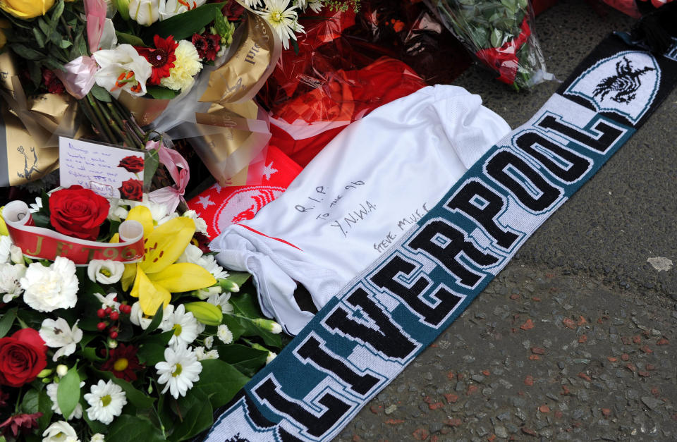 Tributes are laid at the memorial of the Hillsborough disaster outside Anfield before the English Premier League soccer match between Liverpool and Manchester City at Anfield in Liverpool, England, Sunday April. 13, 2014. (AP Photo/Clint Hughes)