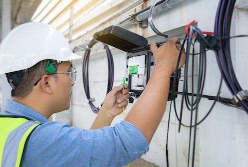 <span class="caption">BT's transition from copper wiring to fibre-optic cabling is now reaching its end.</span> <span class="attribution"><a class="link " href="https://www.shutterstock.com/image-photo/engineer-technician-checking-fiber-optic-cables-2030176718" rel="nofollow noopener" target="_blank" data-ylk="slk:SatawatK / Shutterstock;elm:context_link;itc:0">SatawatK / Shutterstock</a></span>