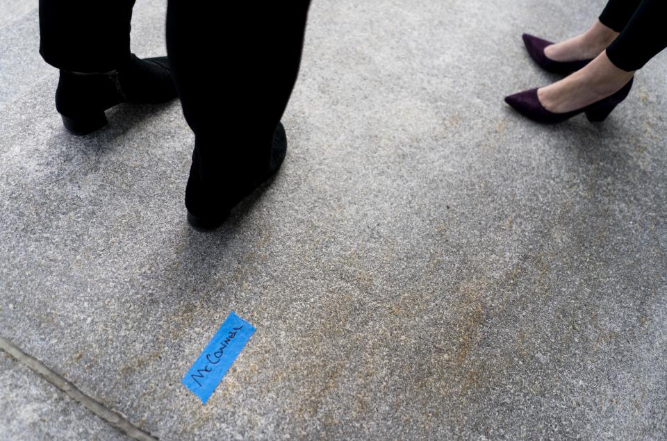 On the East side of the U.S. Capitol, a piece of tape marks the name McConnell as people participate in a rehearsal for the 59th inaugural ceremony for President-elect Joe Biden and Vice President-elect Kamala Harris on Monday, Jan. 18, 2021, in Washington. (Melina Mara/The Washington Post via AP, Pool)