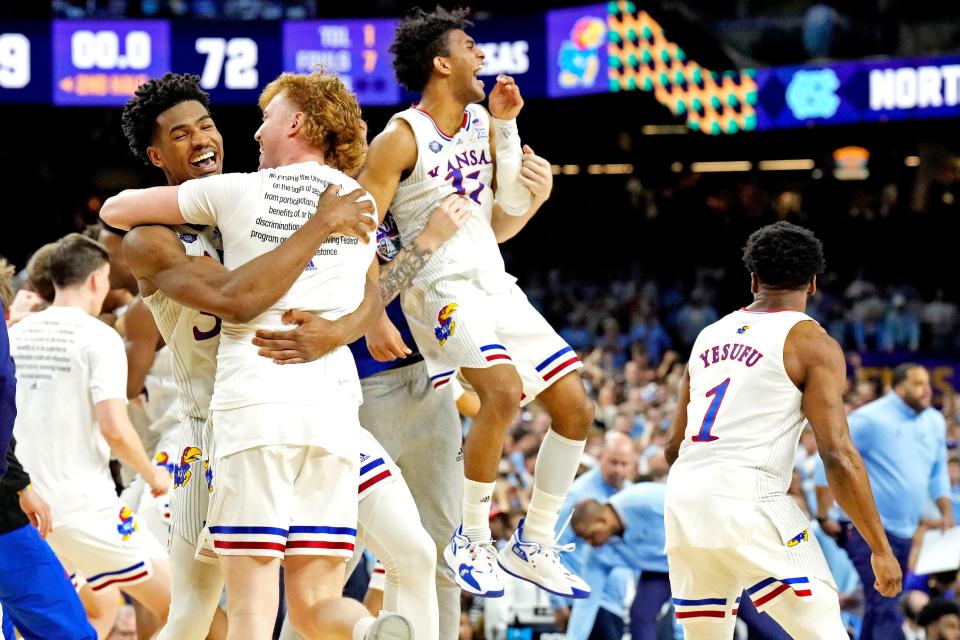 Kansas players celebrate after beating North Carolina during the championship game of the 2022 NCAA men's basketball tournament at Caesars Superdome.