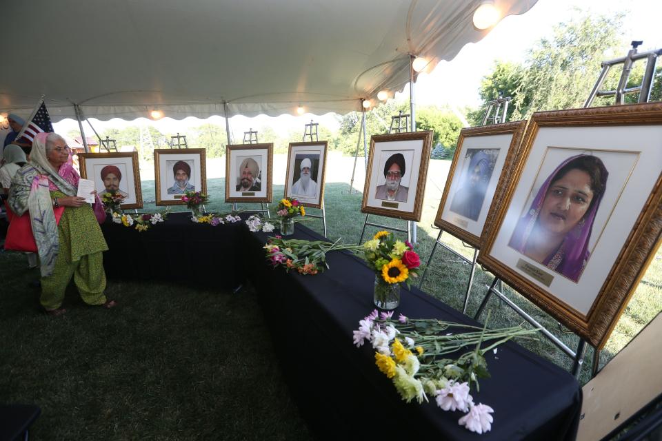 A memorial, from left, displays photos of the victims of the Aug. 5, 2012, Sikh Temple of Wisconsin shooting: Prakash Singh (who died in early 2020 from complications related to his injuries from the attack), Sita Singh, Satwant Singh Kaleka, Baba Punjab Singh, Suveg Singh Khattra, Ranjit Singh and Paramjit Kaur.