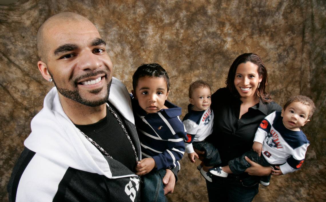In this 2008 file photo, Utah Jazz basketball player Carlos Boozer poses with his son Carmani as his wife CeCe holds twins Cameron and Cayden, right, during a portrait taken in Salt Lake City. Douglas C. Pizac/ASSOCIATED PRESS