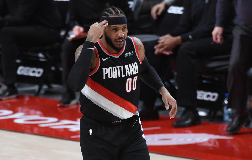Feb 12, 2021; Portland, Oregon, USA; Portland Trail Blazers forward Carmelo Anthony (00) reacts after hitting a three point shot during the second half of the game against the Cleveland Cavaliers at Moda Center. 