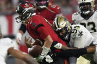 Tampa Bay Buccaneers quarterback Tom Brady (12) fumbles the football after getting hit by New Orleans Saints defensive end Cameron Jordan (94) during the second half of an NFL football game Sunday, Dec. 19, 2021, in Tampa, Fla. (AP Photo/Jason Behnken)