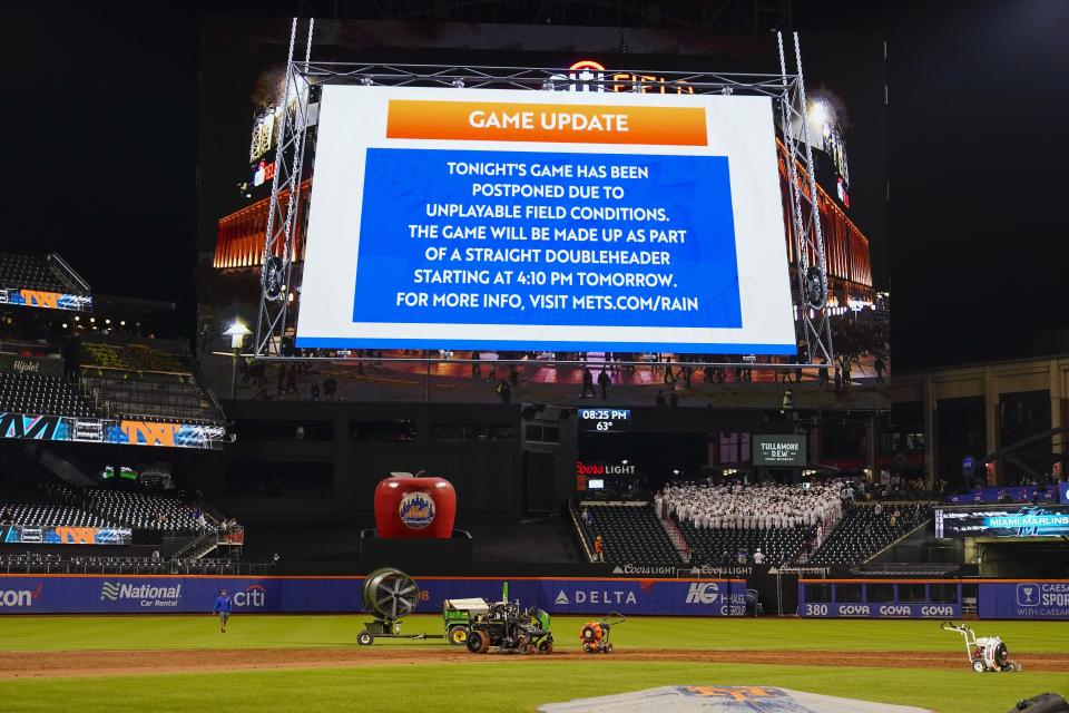 Ground crews work on the field at Citi Field after a baseball game between the New York Mets and the Miami Marlins was postponed due to unplayable field conditions Tuesday, Sept. 26, 2023, in New York. (AP Photo/Frank Franklin II)