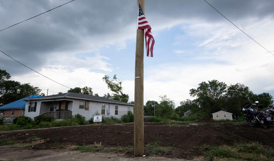 An American flag flies on a utility pole at Sam Brown's homesite Wednesday, July 22, 2020 in Nashville, Tenn. A tornado ripped through the North Nashville neighborhood March 3, 2020 demolishing homes early that morning.