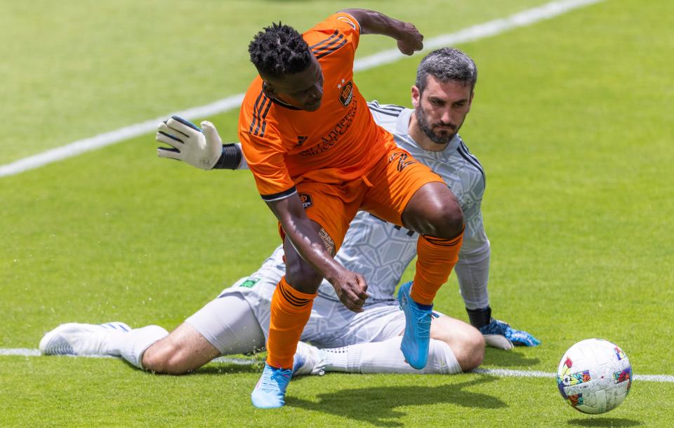 Austin FC goalkeeper Andrew Tarbell goes to the ground to stop Houston's Darwin Quintero during Austin's 2-1 win April 30. Tarbell came in when Brad Stuver suffered a knee injury.