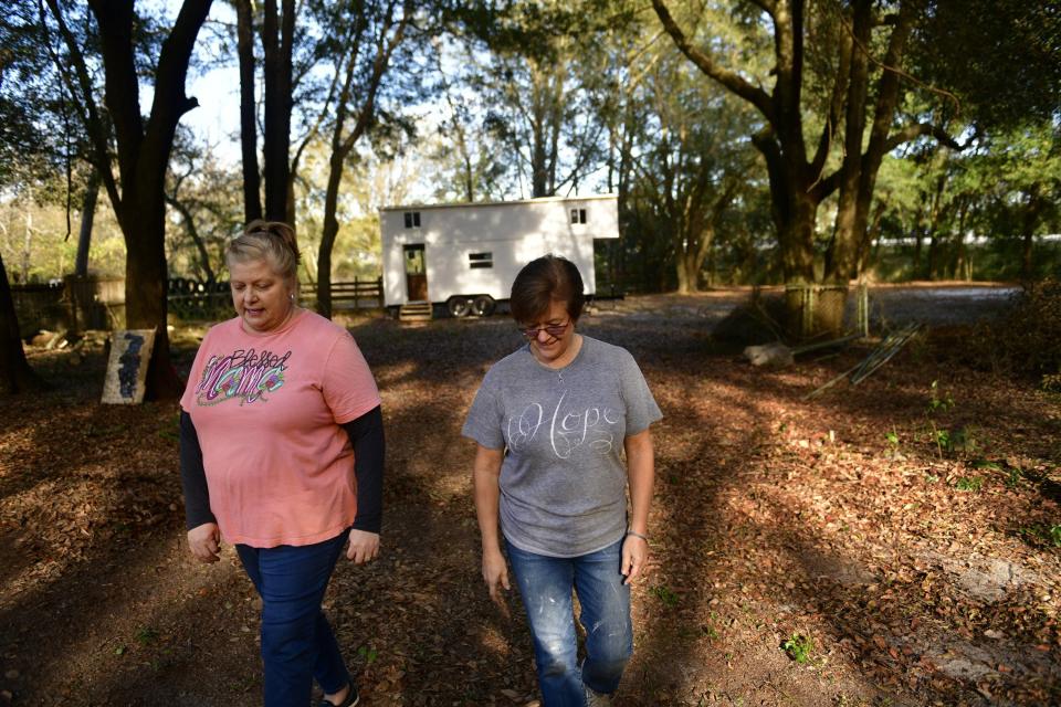 Founders Carla Sweeney (left) and Donna Fenchel walk their 1.3 acre-lot in Jacksonville. Their new nonprofit, The Villages of Hope, is building a tiny-home community on the Westside site for human-trafficking survivors.