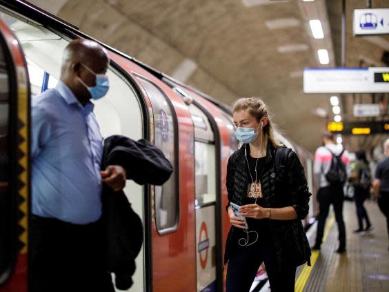 Commuters in London wear face masks following the introduction of new rules on Monday (AFP via Getty)