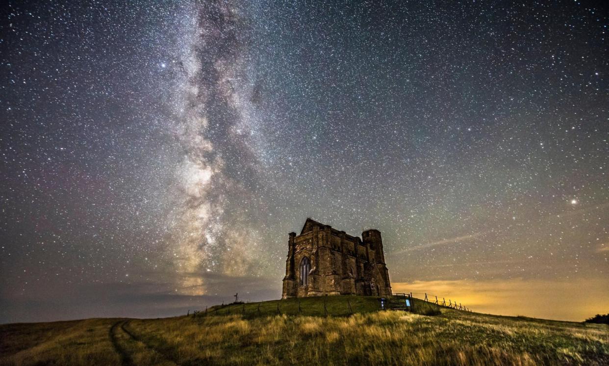 <span>The Milky Way glows in a clear night sky above St Catherine’s Chapel, Abbotsbury, Dorset, August 2021.</span><span>Photograph: Graham Hunt/Alamy</span>