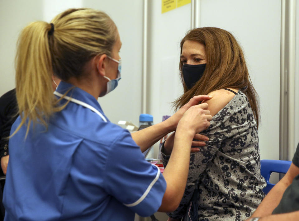 Caroline Nicolls receive an injection of the Moderna Covid-19 vaccine administered by nurse Amy Nash, at the Madejski Stadium in Reading, Berkshire. The Moderna vaccine is the third to be approved for use in the UK, and is now being given to patients in England. Picture date: Tuesday April 13, 2021.