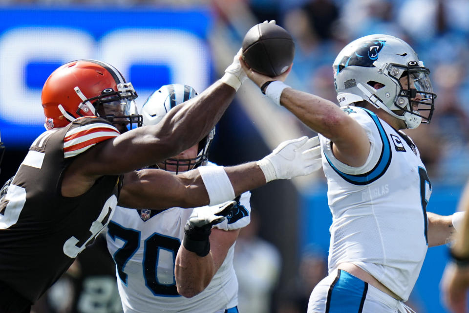 Carolina Panthers quarterback Baker Mayfield passes under pressure from Cleveland Browns defensive end Myles Garrett during the second half of an NFL football game on Sunday, Sept. 11, 2022, in Charlotte, N.C. (AP Photo/Rusty Jones)