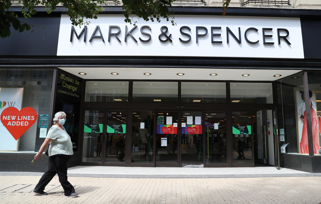 Marks & Spencer A person wearing a face mask makes their way past Marks and Spencer as they walk along Broadmead in Bristol, as face coverings become mandatory in shops and supermarkets in England.