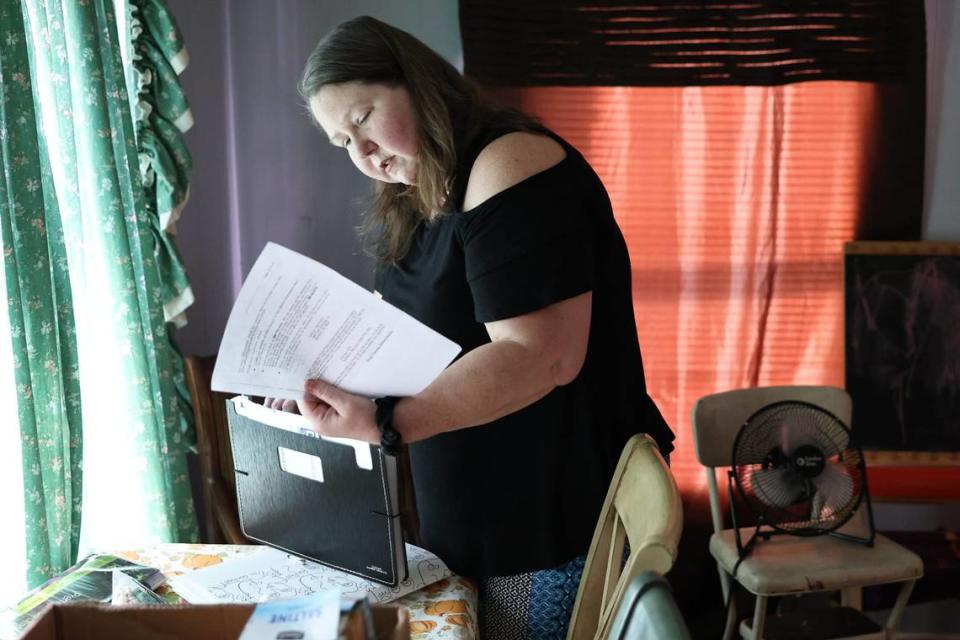 DeAnna Brandon’s, 45, of Salisbury looks through some of her medical bills and documents in August 2023. Brandon was recently diagnosed with multiple myeloma, a rare blood cancer. Brandon does not have insurance and charity care, through which hospitals provide free or discounted services to eligible low-income patients, won’t cover the cost of up to $200,000 to harvest and transplant her own stem cells.
