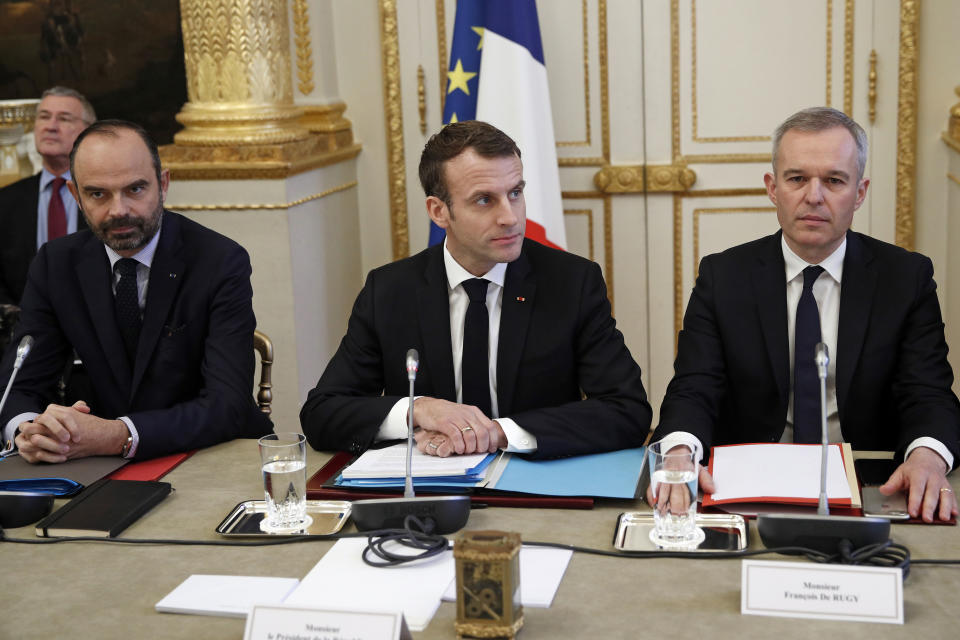 French President Emmanuel Macron, center, French Prime Minister Edouard Philipppe, left, and Environment Minister Francois de Rugy meet with representatives of trade unions, employers' organizations and local elected officials at the Elysee Palace in Paris, Monday, Dec.10 2018. Macron is preparing to speak to the nation Monday at last, after increasingly violent and radicalized protests against his leadership and a long silence that aggravated the anger. (Yoan Valat, Pool via AP)