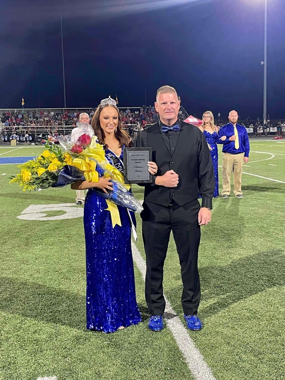 Homecoming Queen Addie Shelton shares a proud moment with her father, Michael Shelton (in matching blue sequined shoes), at homecoming at Karns High School, Sept. 15, 2023.