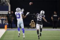 Dallas Cowboys wide receiver Michael Gallup (13) reaches up to catch a long pass as Las Vegas Raiders cornerback Casey Hayward Jr. (29) defends in the second half of an NFL football game in Arlington, Texas, Thursday, Nov. 25, 2021. (AP Photo/Michael Ainsworth)