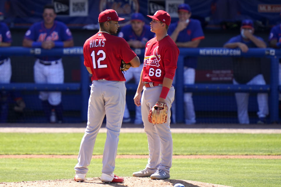 St. Louis Cardinals relief pitcher Jordan Hicks (12) talks with third baseman Nolan Gorman (68) after walking New York Mets' Luis Guillorme during the fifth inning of a spring training baseball game, Sunday, March 14, 2021, in Port St. Lucie, Fla. (AP Photo/Lynne Sladky)