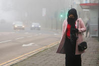  A woman wearing a face mask walks on the street on a foggy morning, as many parts of the UK are now in Tier 4 COVID-19 restrictions. The UK has recorded its highest daily rise in coronavirus cases since the pandemic began with 41,385 positive tests. Prime Minister Boris Johnson hasn't ruled out a national lockdown in the New Year. (Photo by Dinendra Haria / SOPA Images/Sipa USA) 