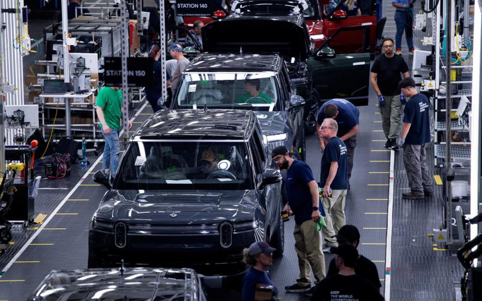 Workers assemble second-generation R1 vehicles at electric auto maker Rivian's manufacturing facility in Normal, Illinois