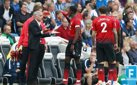 Manchester United's manager Jose Mourinho gestures as he speaks to Paul Pogba during the English Premier League soccer match between Brighton and Hove Albion and Manchester United at the Amex stadium - Credit:  AP